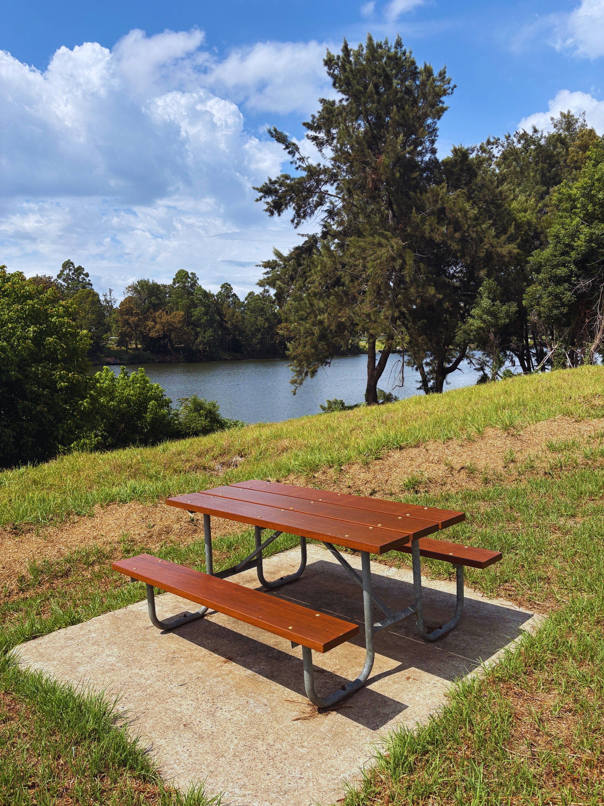 An image of a picnic table with the Nepean River in the background.