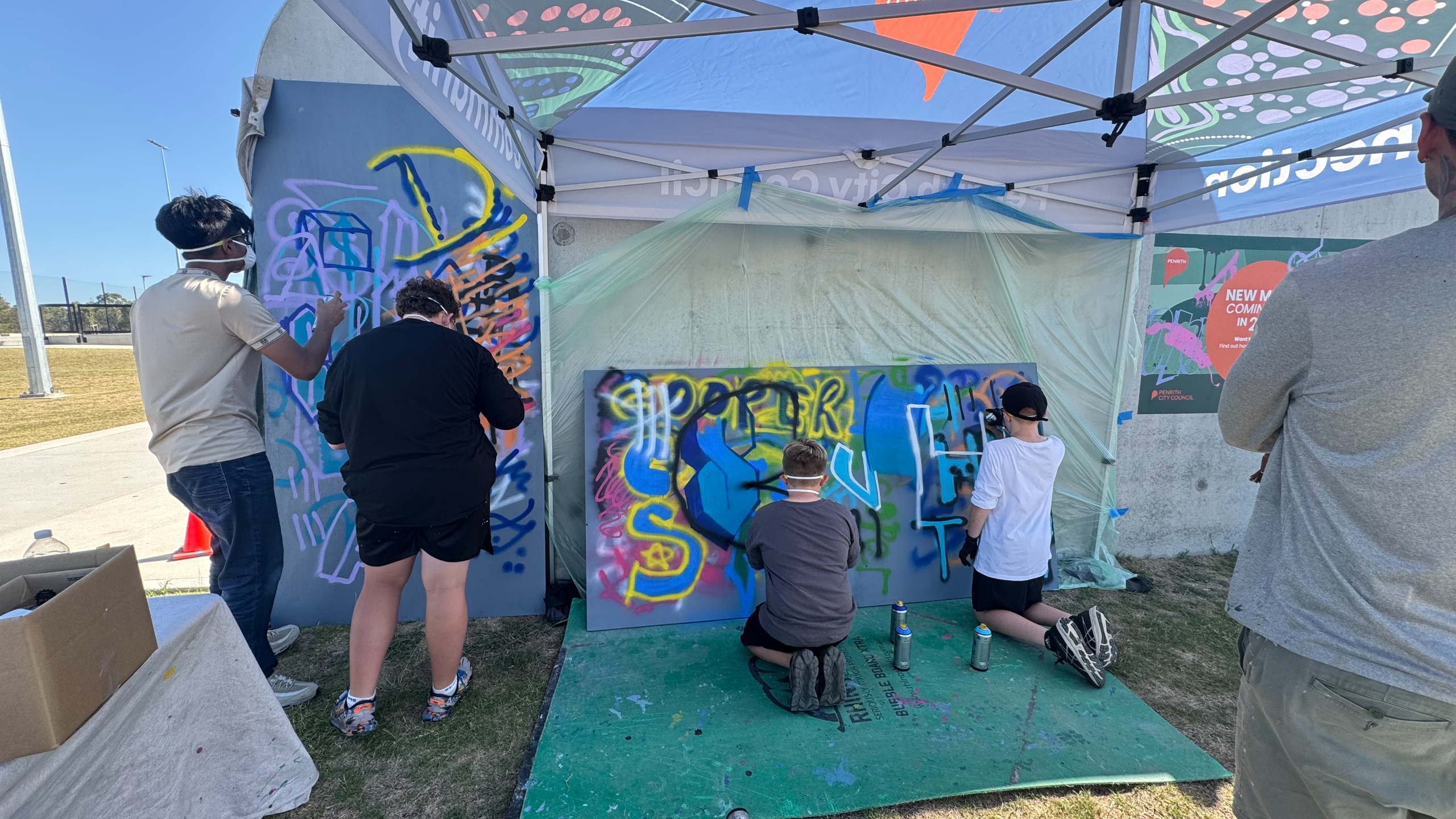 An image of young people painting a mural