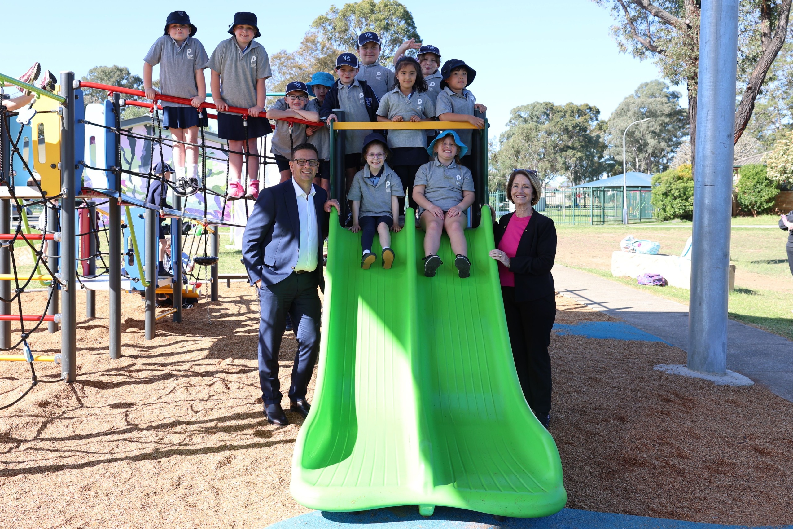 Penrith Mayor Todd Carney and Member for Penrith Karen McKeown visiting the new playspace at Eileen Cammack Reserve, South Penrith, with children from York OSHC and Tandara Children's Centre OSHC.
