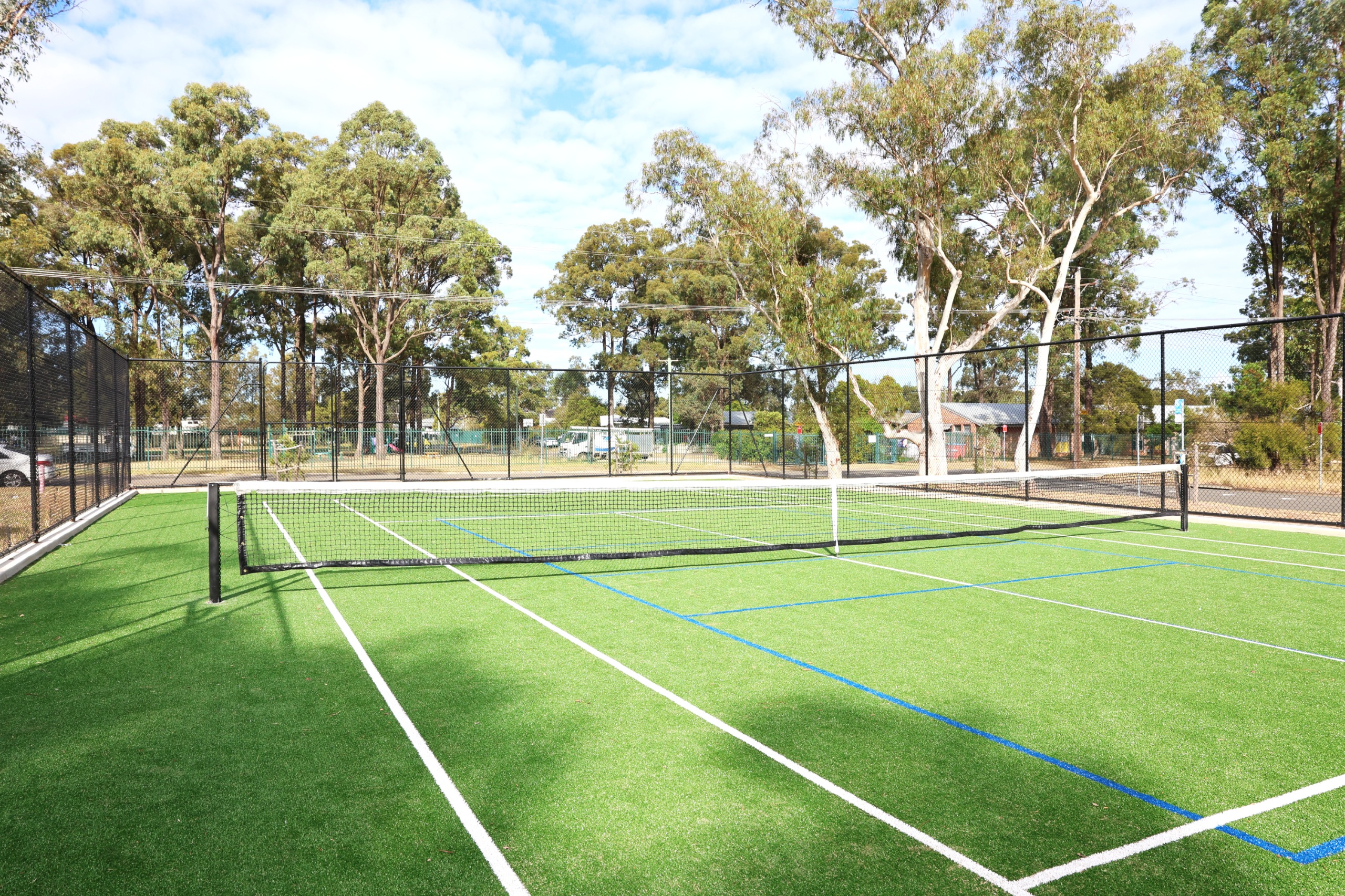 Resurfaced tennis court and fencing